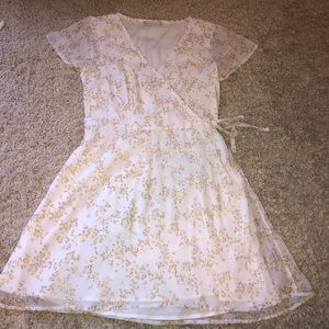 Yellow flowered dress, clipped in the front